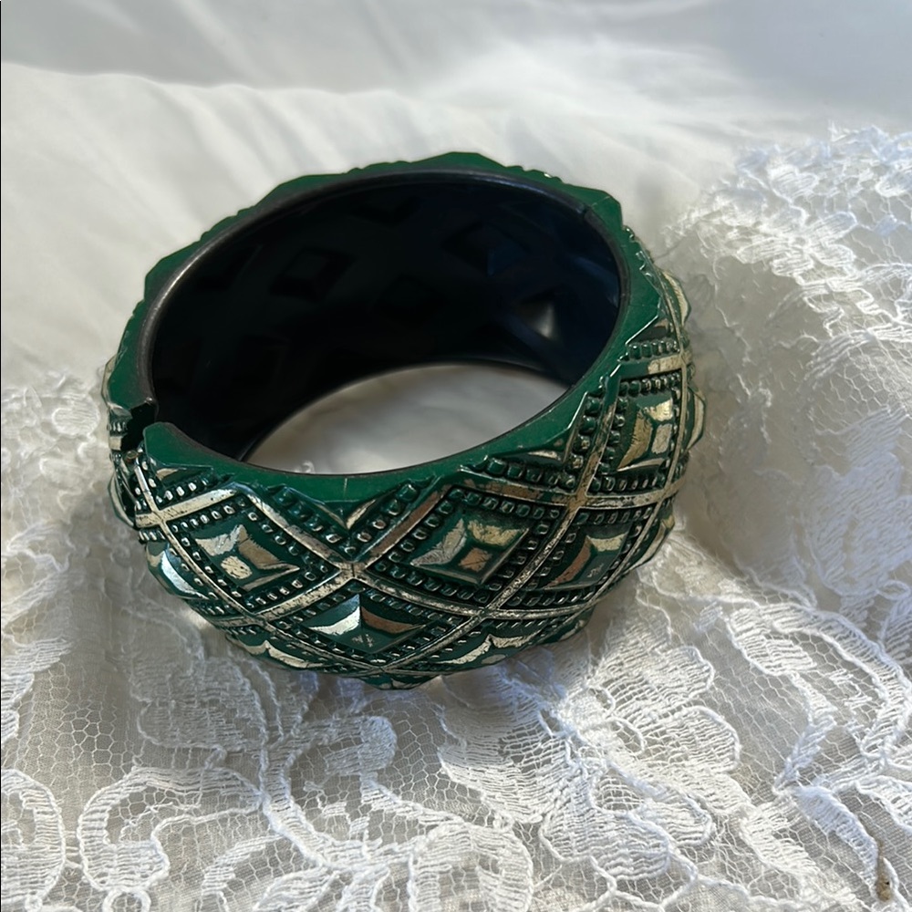 Vintage plastic cuff bracelet. 1 1/2” wide. Hinged opening. Green and silver.